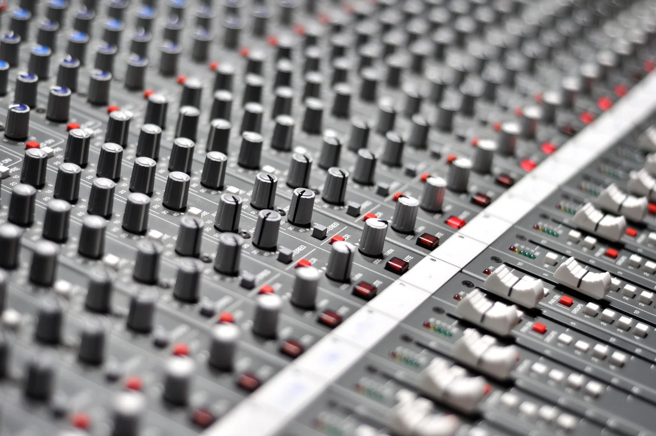 Mixing console with faders.